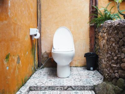Rustiek toilet met okergele wand en patroontegels